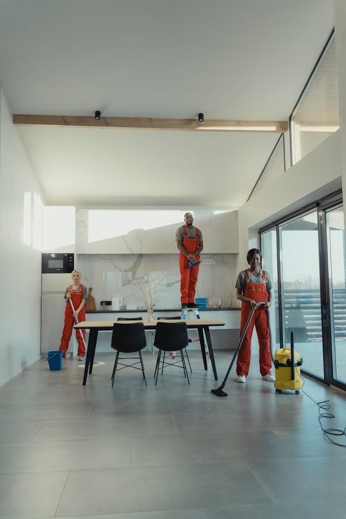 about-01 Team of professional cleaners working in a spacious, modern indoor setting.